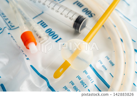Foley urinary catheter with urine bag for disability or patient in hospital. Foley urinary catheter with urine bag for disability or patient in hospital. 142883826