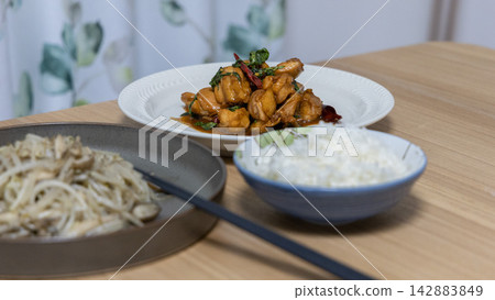 Three Chinese dishes lined up on a wooden table Three Chinese dishes lined up on a wooden table 142883849