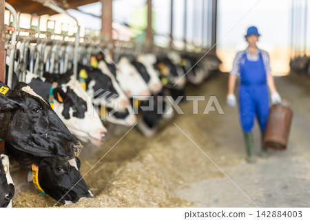 man holding a gas cylinder on a farm man holding a gas cylinder on a farm 142884003