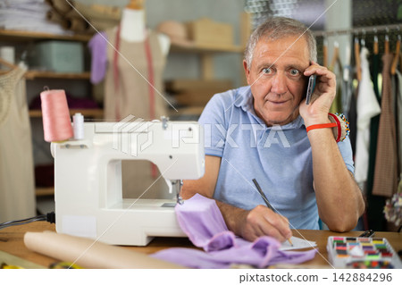 Mature male tailor resting Mature male tailor resting 142884296