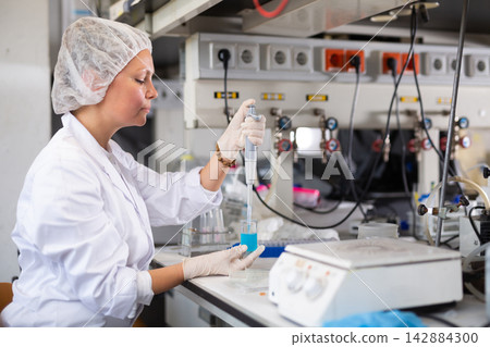 Young adult woman lab technician at work Young adult woman lab technician at work 142884300
