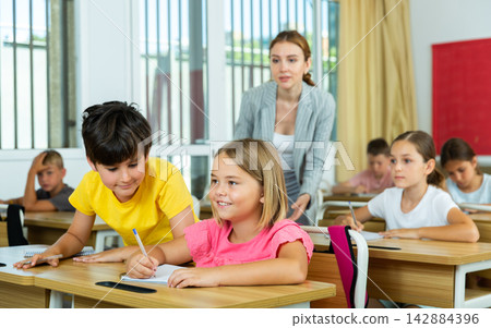 Schoolchildren performing test Schoolchildren performing test 142884396