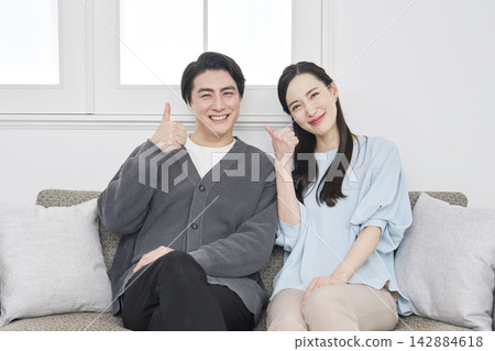 Middle-aged couple living room good sign Middle-aged couple living room good sign 142884618