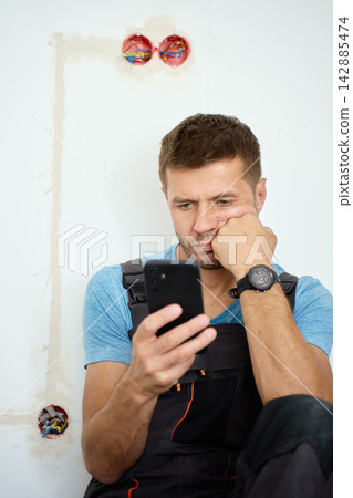 Worried man searching repair advice online during renovation Worried man searching repair advice online during renovation 142885474