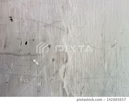 Weathered grey painted wall texture featuring fine scratches, smudges and worn brush strokes for abstract rustic background design. Weathered grey painted wall texture featuring fine scratches, smudges and worn brush strokes for abstract rustic background design. 142885657