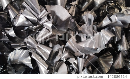 Steel scrap materials recycling. Aluminum chip waste after machining metal parts on a cnc lathe. Closeup twisted spiral steel shavings. Small roughness sharpness, Steel scrap materials recycling. Aluminum chip waste after machining metal parts on a cnc lathe. Closeup twisted spiral steel shavings. Small roughness sharpness, 142886514