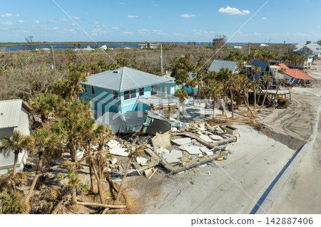 Ruined buildings in need of demolition or repair. Storm surge water and wind damaged houses roof and collapsed walls after hurricane in Florida Ruined buildings in need of demolition or repair. Storm surge water and wind damaged houses roof and collapsed walls after hurricane in Florida 142887406
