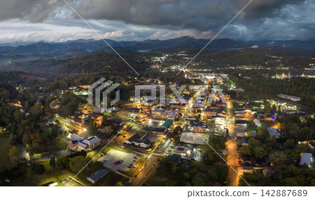 Aerial panorama of evening Franklin, North Carolina with small town architecture, tourist infrastructure and Great Smoky Mountains nearby. 142887689