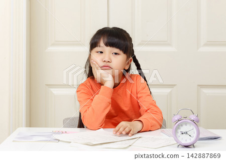 Bored little girl leaning on her hands and looking away with a dissatisfied expression. Bored little girl leaning on her hands and looking away with a dissatisfied expression. 142887869
