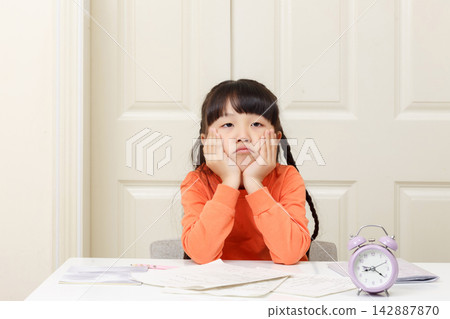 Bored little girl leaning on her hands and looking away with a dissatisfied expression. Bored little girl leaning on her hands and looking away with a dissatisfied expression. 142887870