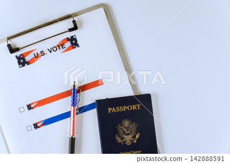 Clipboard with voting form, US passport, pen are placed on white surface. Clipboard with voting form, US passport, pen are placed on white surface. 142888591