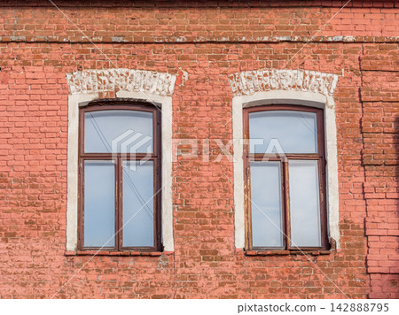 Two windows of the old mansion 19 century with brown bricks wall Two windows of the old mansion 19 century with brown bricks wall 142888795