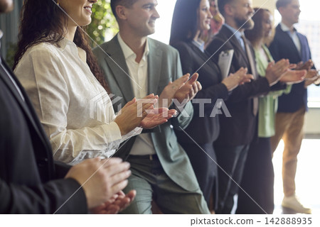 Business audience applauding at seminar workshop, recognition and team motivation Business audience applauding at seminar workshop, recognition and team motivation 142888935