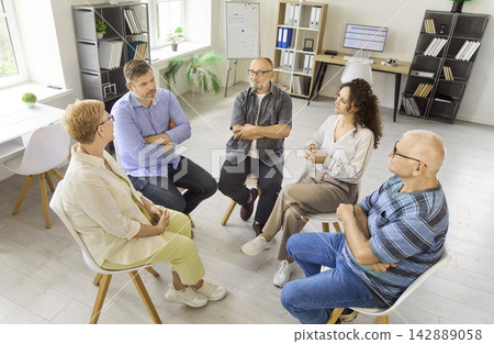 Senior support group in therapy circle discussing life experiences and mutual help Senior support group in therapy circle discussing life experiences and mutual help 142889058