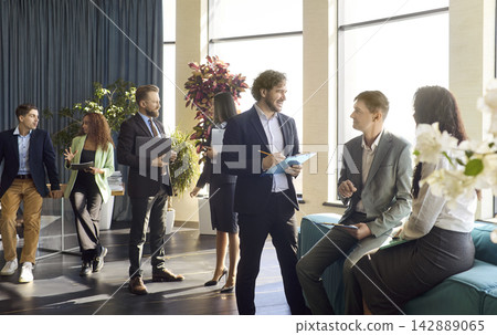 Business team networking during corporate workshop in a bright modern office Business team networking during corporate workshop in a bright modern office 142889065