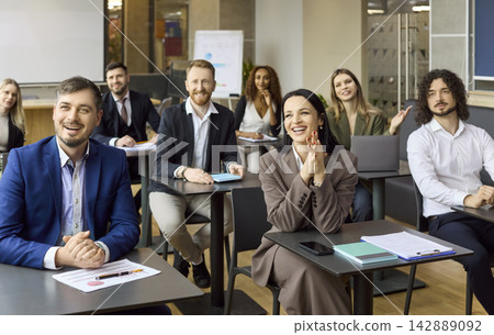 Happy diverse business team in corporate training workshop session with coach Happy diverse business team in corporate training workshop session with coach 142889092