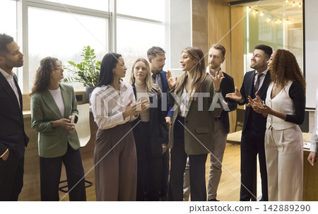Diverse business team applauding leader during office meeting and presentation Diverse business team applauding leader during office meeting and presentation 142889290