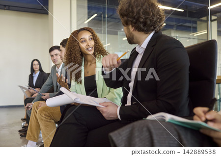 Business colleagues talking during seminar workshop meeting inside modern office Business colleagues talking during seminar workshop meeting inside modern office 142889538