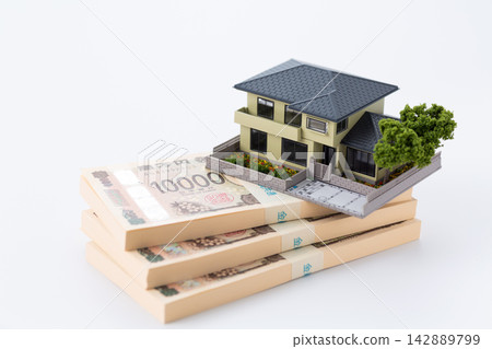 A stack of 3 million yen bills and a model house 142889799