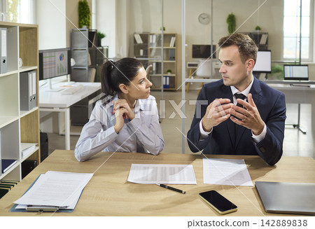 Banker consulting client about loan approval, paperwork and finance in office Banker consulting client about loan approval, paperwork and finance in office 142889838