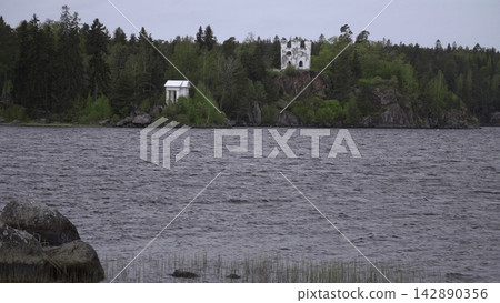 Coastal Landscape With Forest And Castle. Seaside Cliffs With Pine Trees And Distant Fortress. Creative 142890356