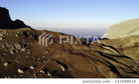 Rocky mountain slope with cliffs and distant horizon 142890619