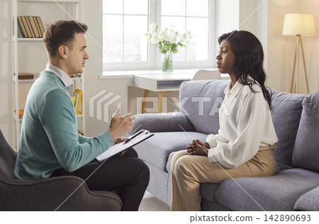 African American woman talking to male doctor, provides expert advice professionally, information African American woman talking to male doctor, provides expert advice professionally, information 142890693