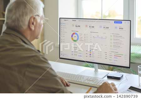 Senior man budgeting on computer at home, analyzing expenses, retirement savings Senior man budgeting on computer at home, analyzing expenses, retirement savings 142890739
