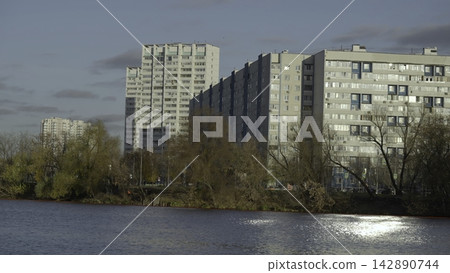 Sunlit City Waterfront Scenes. Modern Apartment Blocks With Autumn Foliage And Reflective Water Surfaces. Creative Sunlit City Waterfront Scenes. Modern Apartment Blocks With Autumn Foliage And Reflective Water Surfaces. Creative 142890744