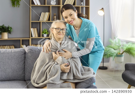 Senior woman with caregiver nurse at home, comforting care and support concept Senior woman with caregiver nurse at home, comforting care and support concept 142890930