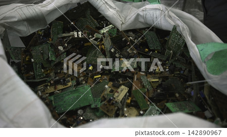 Multiple Personnel Work In Unison To Disassemble And Sort Circuit Boards Efficiently At Recycling Facility . Media Multiple Personnel Work In Unison To Disassemble And Sort Circuit Boards Efficiently At Recycling Facility . Media 142890967