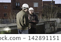 Engineers Inspect Roofs. Engineers Collaboratively Examine And Quantify Roof And Climate Control Systems. Media 142891151