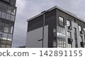 Contemporary Apartment With Detailed Rooftop. Glass Balcony And Brick Textures On Modern Building. Stock Clip 142891155