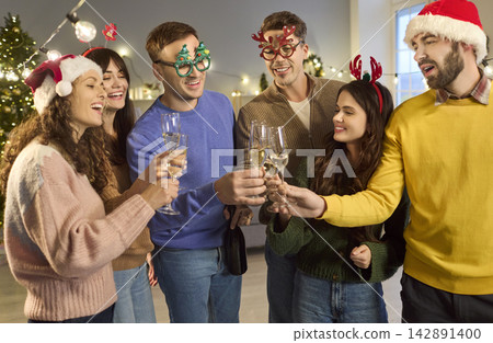 Friends in Santa Hats Toasting Champagne at Festive Christmas Home Party Tonight Friends in Santa Hats Toasting Champagne at Festive Christmas Home Party Tonight 142891400