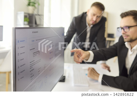 Manager points at analytics dashboard during corporate data review meeting Manager points at analytics dashboard during corporate data review meeting 142891622