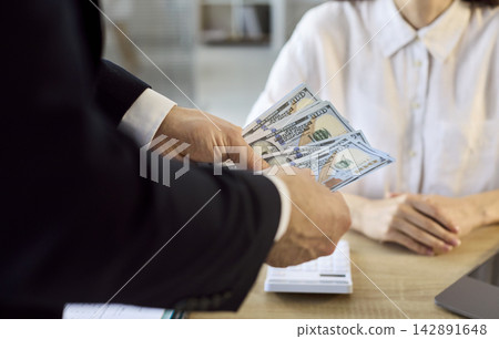 Employer paying cash salary to employee in office, payroll and finance Employer paying cash salary to employee in office, payroll and finance 142891648