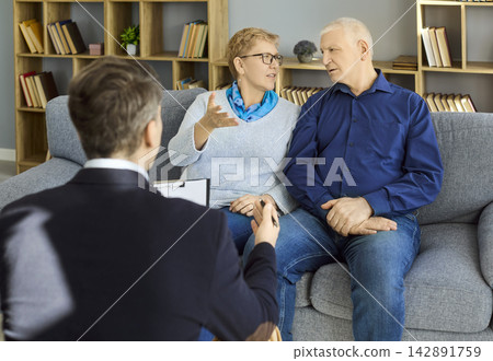 Psychologist guiding senior couple in counseling session for communication Psychologist guiding senior couple in counseling session for communication 142891759