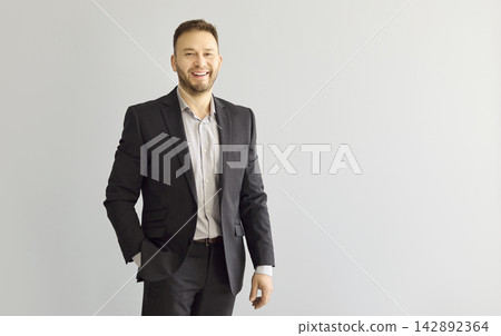 Confident smiling businessman portrait in suit on gray background with copy space Confident smiling businessman portrait in suit on gray background with copy space 142892364