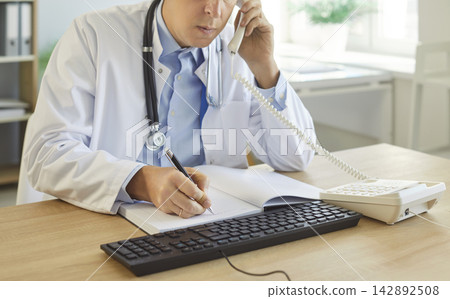 Close-Up Of Nurse On Phone Call In Clinic Close-Up Of Nurse On Phone Call In Clinic 142892508