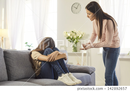 Angry strict mother lecturing her naughty daughter, yelling and scolding small girl 142892657