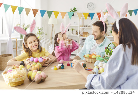 Happy family gather together for decorating Easter eggs Happy family gather together for decorating Easter eggs 142893124