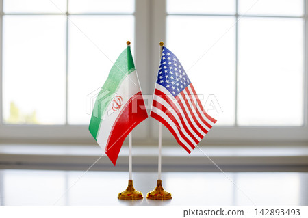 Iran and USA desk flags symbolizing diplomacy, negotiations, resolution and peace 142893493