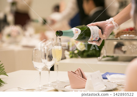 Image of champagne being poured at a formal restaurant Image of champagne being poured at a formal restaurant 142893522