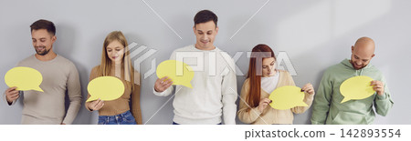 Banner with a group of happy young people holding empty yellow message bubble cards Banner with a group of happy young people holding empty yellow message bubble cards 142893554