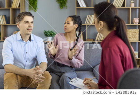 Couple with therapist in counseling session on relationship conflict communication Couple with therapist in counseling session on relationship conflict communication 142893912
