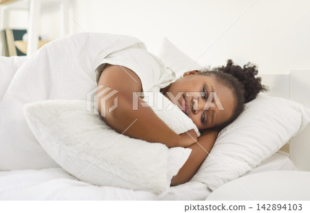 African American Woman Sleeping Peacefully At Home In The Early Morning African American Woman Sleeping Peacefully At Home In The Early Morning 142894103