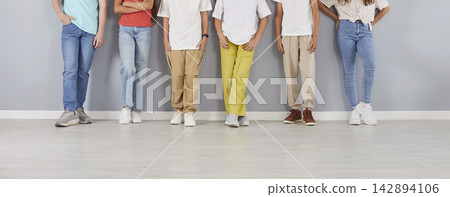 Midsection Group Portrait Of Students On Grey Background Midsection Group Portrait Of Students On Grey Background 142894106