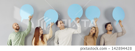 Diverse group of business people, friends holding empty paper speech bubbles, representing talk Diverse group of business people, friends holding empty paper speech bubbles, representing talk 142894428