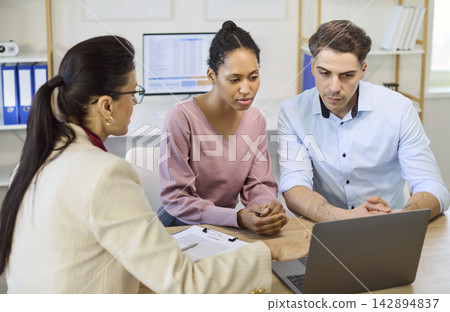 Couple meeting financial advisor for mortgage loan planning and agreement Couple meeting financial advisor for mortgage loan planning and agreement 142894837