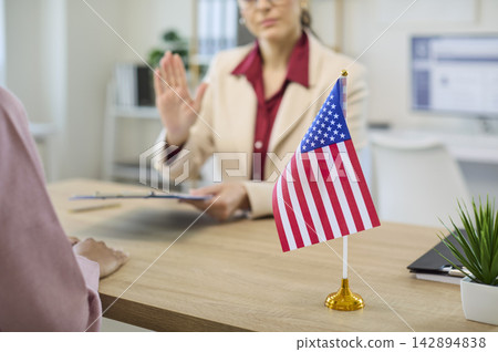 Immigration consultant rejects visa documents during client interview in office USA Immigration consultant rejects visa documents during client interview in office USA 142894838